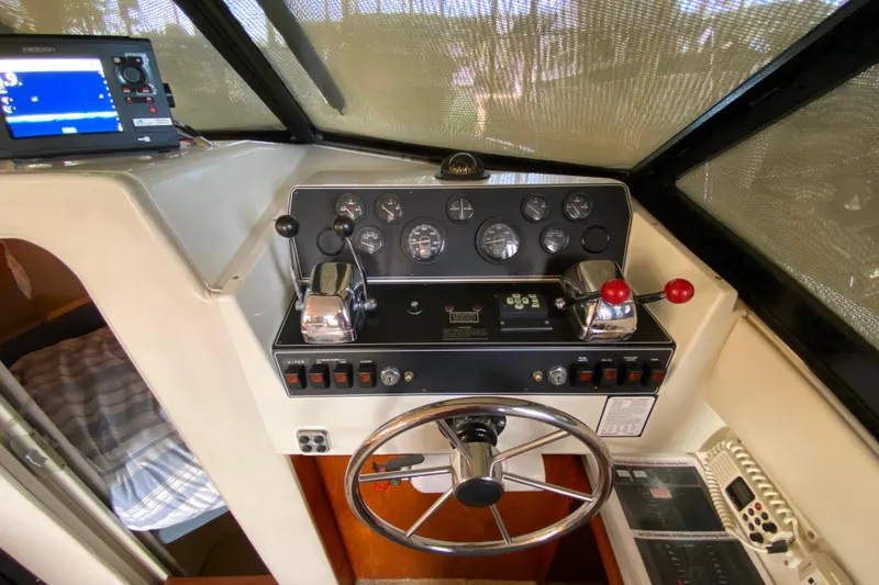 Slide: The Image of 1991 Carver 28 Command Bridge helm with gauges, controls, and navigation equipment. - 27