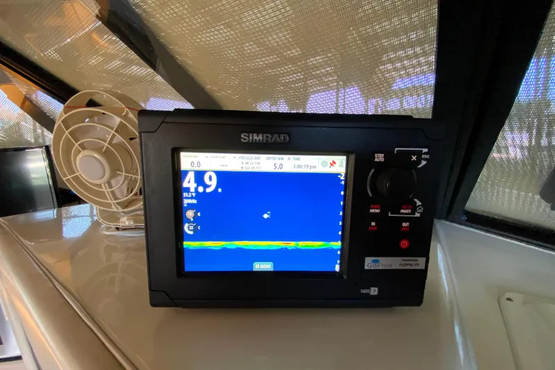 Slide: The Image of Simrad navigation system on 1991 Carver 28 Command Bridge boat dashboard. - 28