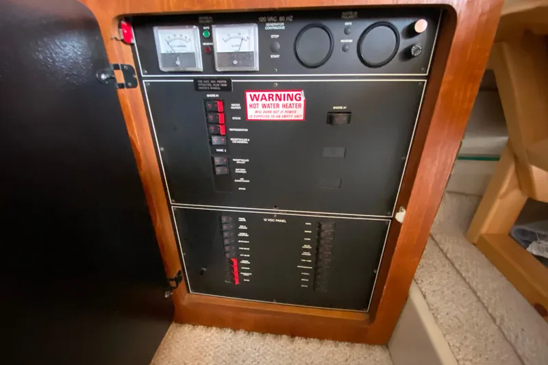 Slide: The Image of Electrical panel of a 1991 Carver 28 Command Bridge boat with warning label. - 29
