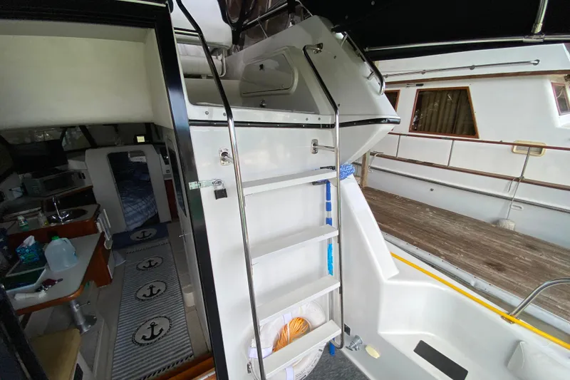 Slide: The Image of Interior view of a 1991 Carver 28 Command Bridge boat with ladder and cabin area. - 35