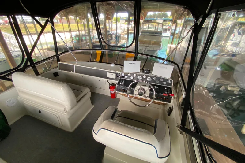 Slide: The Image of Interior view of a 1991 Carver 28 Command Bridge boat cockpit with steering wheel and controls. - 37