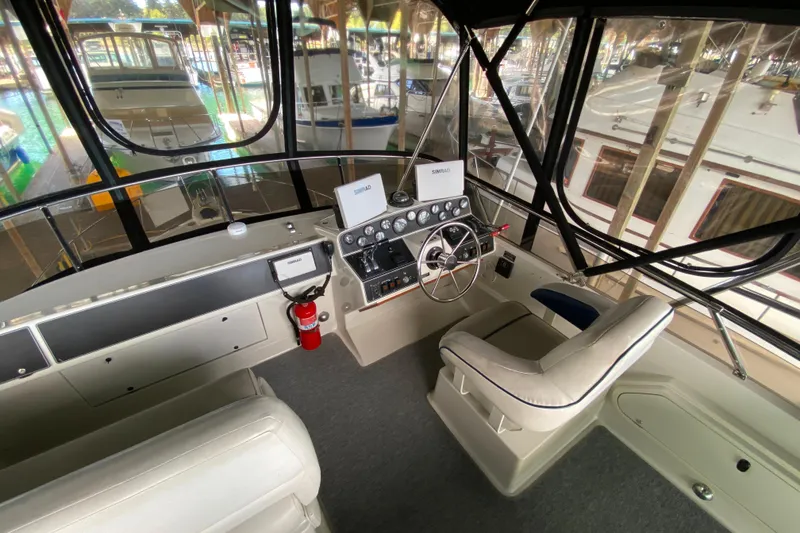 Slide: The Image of Interior view of 1991 Carver 28 Command Bridge boat cockpit with steering wheel and controls. - 38