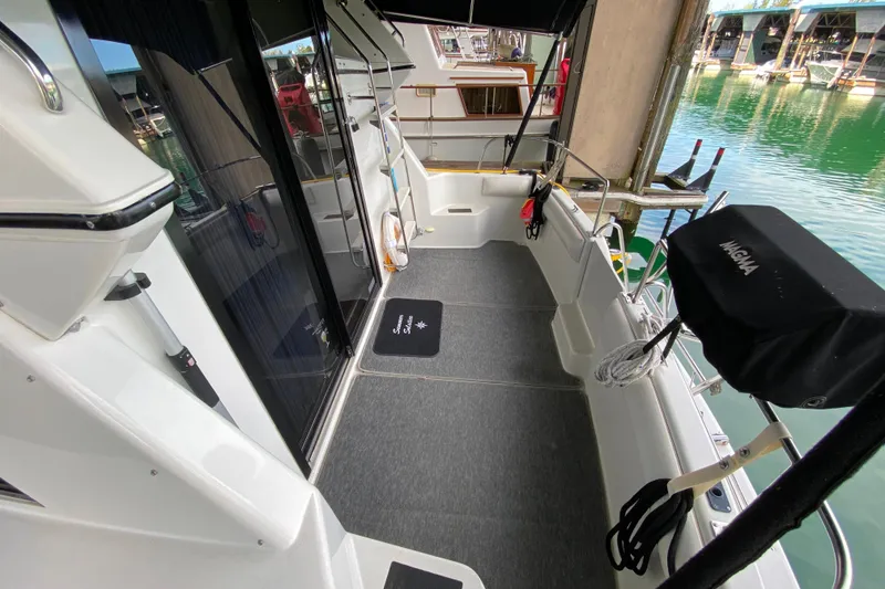 Slide: The Image of 1991 Carver 28 Command Bridge boat deck with marina view, featuring sleek design and modern amenities. - 4