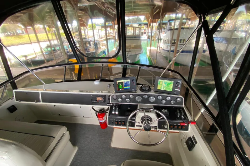 Slide: The Image of Interior view of 1991 Carver 28 Command Bridge cockpit with navigation equipment. - 40