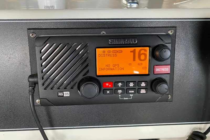 Slide: The Image of Simrad RS35 marine radio displaying distress signal on Carver 28 Command Bridge, 1991 model. - 43