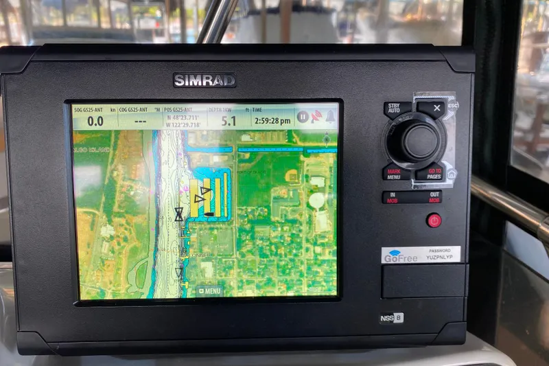 Slide: The Image of Simrad navigation system on a 1991 Carver 28 Command Bridge displaying a detailed map. - 45