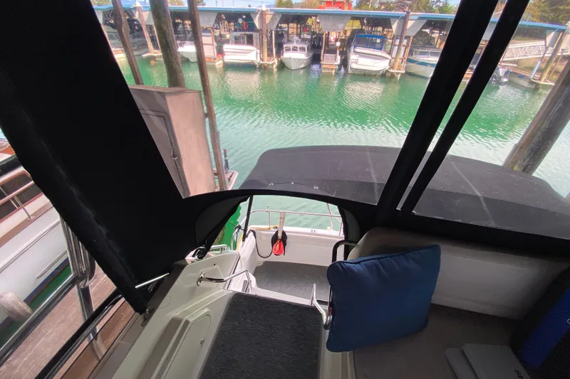Slide: The Image of Interior view of 1991 Carver 28 Command Bridge overlooking marina. - 48