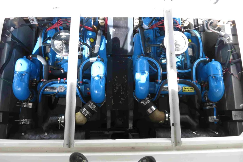 Slide: The Image of Engine compartment of a 1991 Carver 28 Command Bridge with dual blue engines. - 49