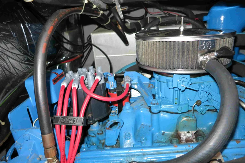 Slide: The Image of Engine compartment of a 1991 Carver 28 Command Bridge with visible air filter and wiring. - 51