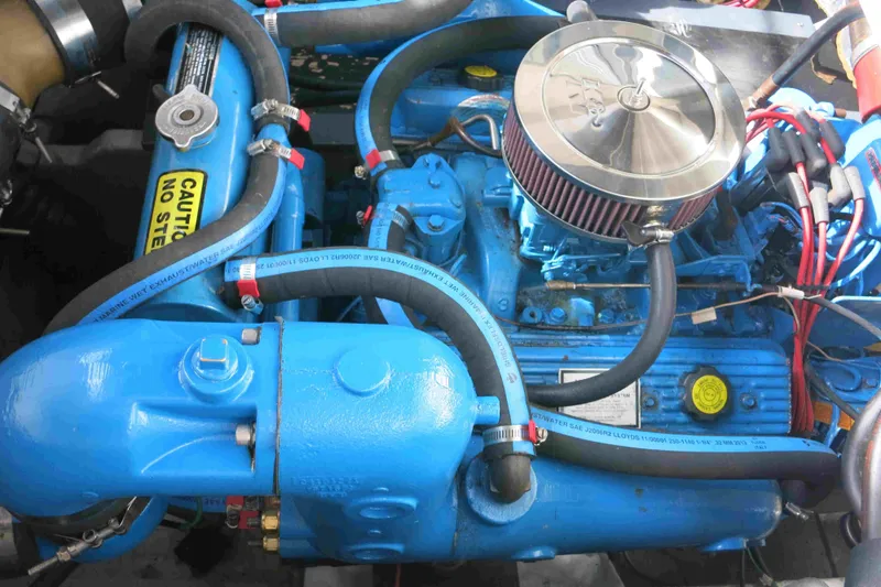 Slide: The Image of Engine of a 1991 Carver 28 Command Bridge, featuring blue components and labeled parts. - 52