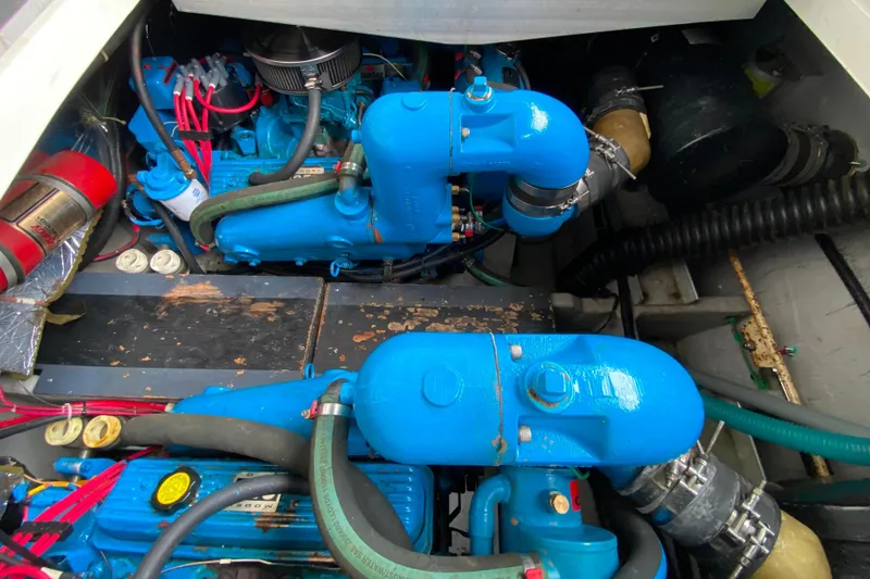 Slide: The Image of Engine compartment of a 1991 Carver 28 Command Bridge with blue components and hoses. - 53