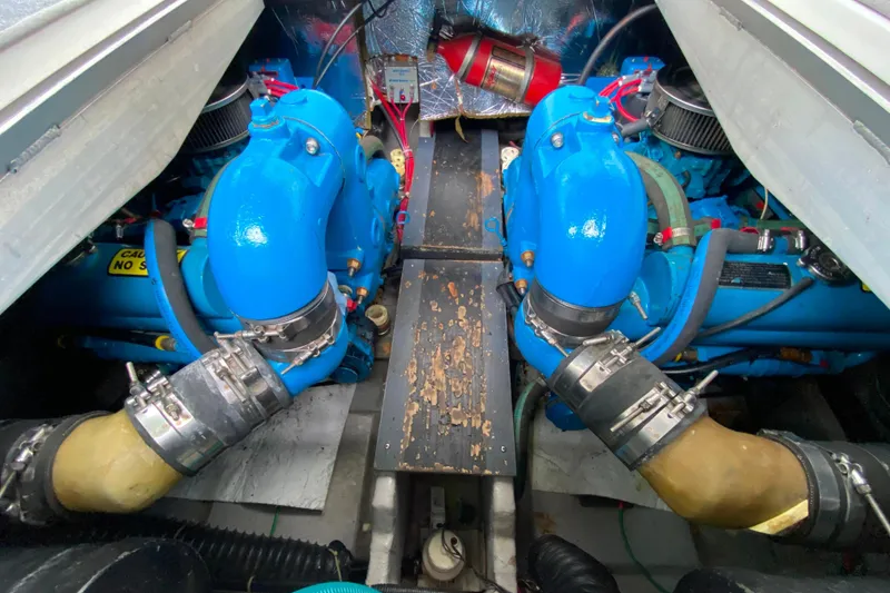 Slide: The Image of Engine compartment of a 1991 Carver 28 Command Bridge with blue components and hoses. - 54