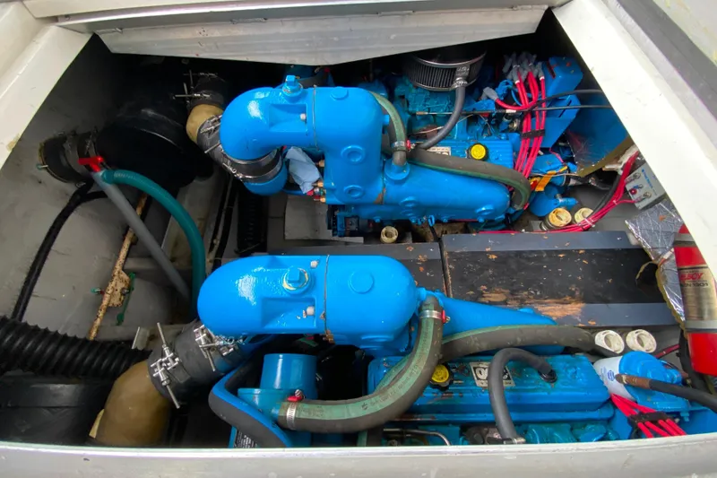Slide: The Image of Engine compartment of a 1991 Carver 28 Command Bridge with blue components and hoses. - 55