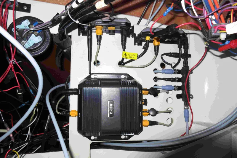 Slide: The Image of Electrical wiring and components inside a 1991 Carver 28 Command Bridge boat. - 56
