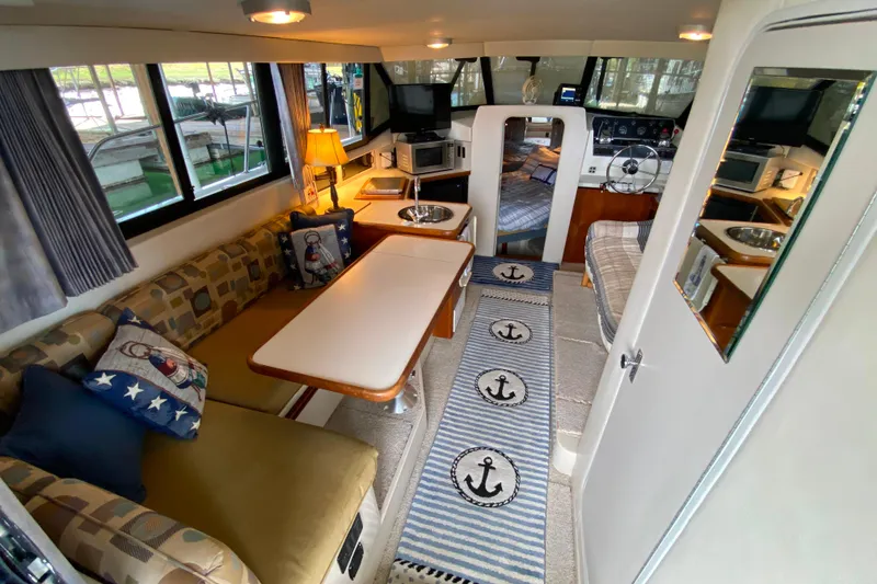 Slide: The Image of Interior of 1991 Carver 28 Command Bridge with cozy seating and nautical decor. - 6