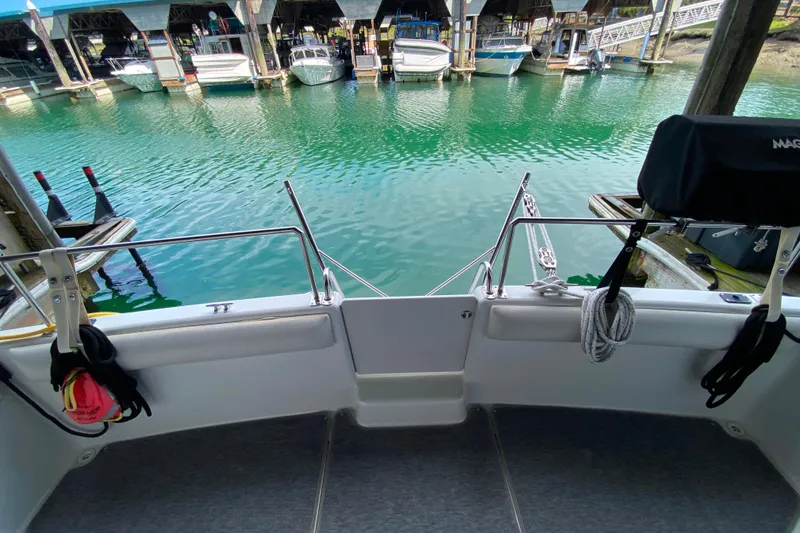 Slide: The Image of 1991 Carver 28 Command Bridge at marina, overlooking calm water and docked boats. - 61