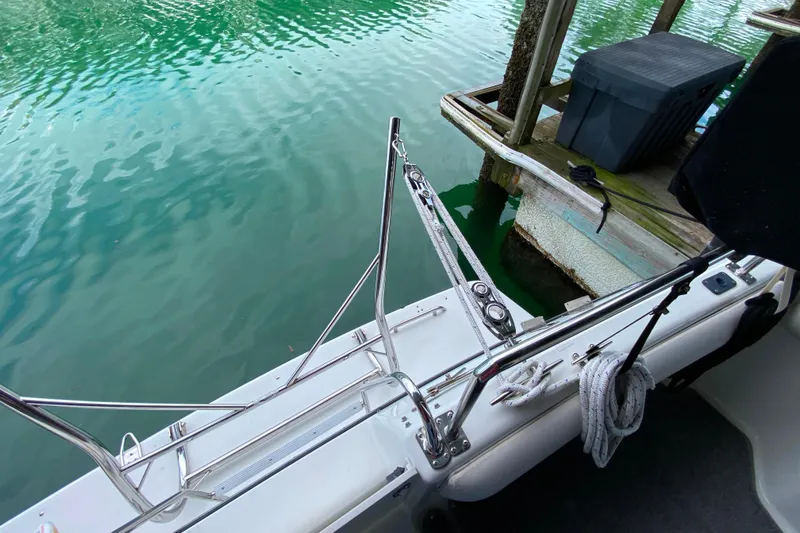 Slide: The Image of 1991 Carver 28 Command Bridge docked, showing stainless steel railings and calm water. - 62