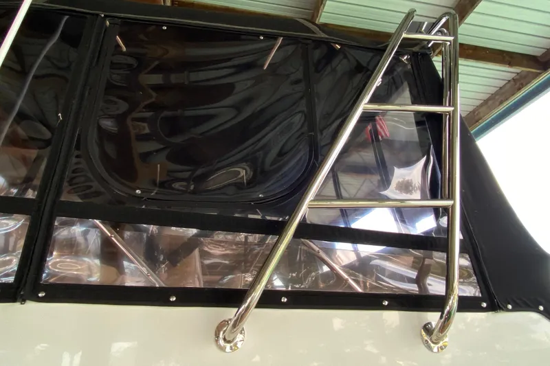 Slide: The Image of Stainless steel ladder on 1991 Carver 28 Command Bridge boat under a canopy. - 68