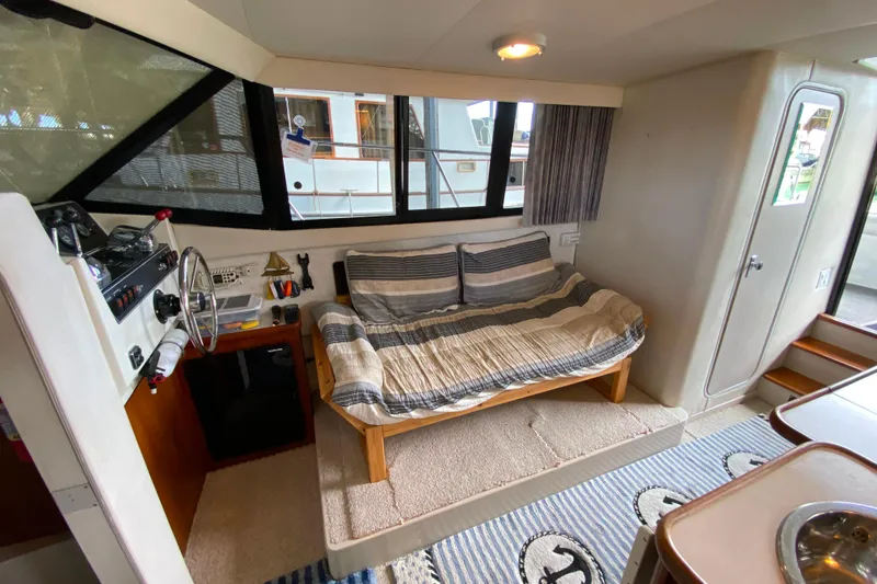 Slide: The Image of Interior of 1991 Carver 28 Command Bridge with cozy seating and helm station. - 8