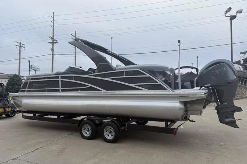 Slide: The Image of 2026 Bennington 25 QFBWA pontoon boat on trailer, featuring sleek design and powerful engine. - 3