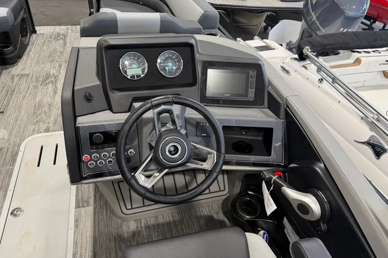 Slide: The Image of 2026 Avalon 2585 25 Catalina QL boat dashboard with steering wheel and control panel. - 7