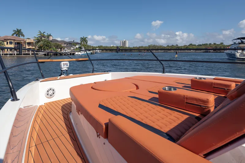 Slide: The Image of Luxurious Hanover 387 yacht deck with orange seating, overlooking waterfront homes and clear skies. - 10