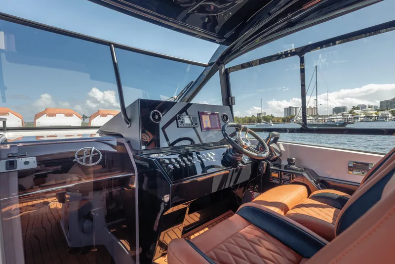 Slide: The Image of Luxurious 2026 Hanover 387 yacht cockpit with leather seating and modern controls. - 14