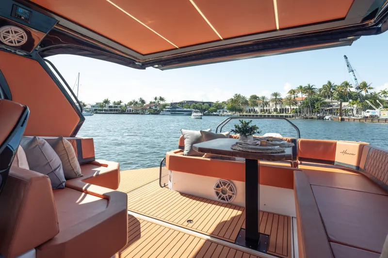 Slide: The Image of Luxurious Hanover 387 yacht interior with elegant seating, table, and waterfront view, 2026 model. - 15