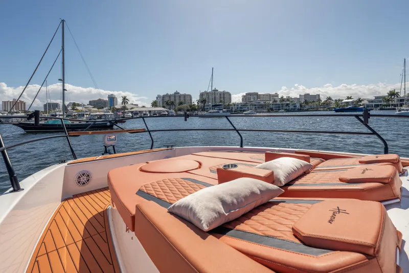 Slide: The Image of Luxurious 2026 Hanover 387 yacht with sunbathing deck, overlooking marina and city skyline. - 18