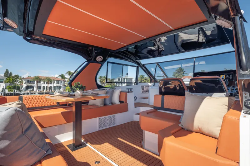 Slide: The Image of Luxurious 2026 Hanover 387 yacht interior with orange seating, elegant table, and scenic waterfront view. - 29