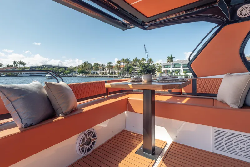 Slide: The Image of Luxurious Hanover 387 yacht interior with orange seating, elegant table, and waterfront view, 2026 model. - 30