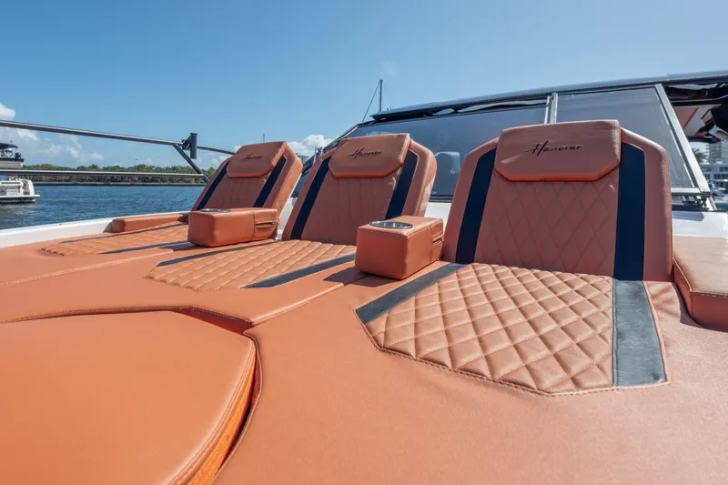 Slide: The Image of Luxurious seating on 2026 Hanover 387 boat with quilted leather design, docked by the water. - 33