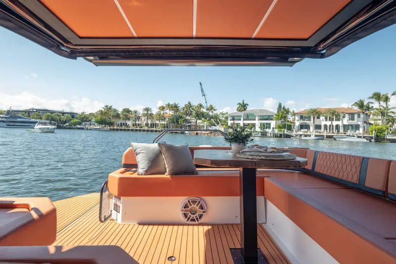 Slide: The Image of Luxurious Hanover 387 yacht interior with waterfront view, featuring elegant seating and table, 2026 model. - 40