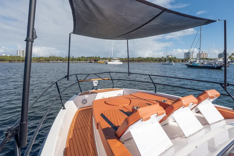 Slide: The Image of Luxury Hanover 387 boat, 2026 model, with sunshade and seating, docked in a scenic marina. - 9