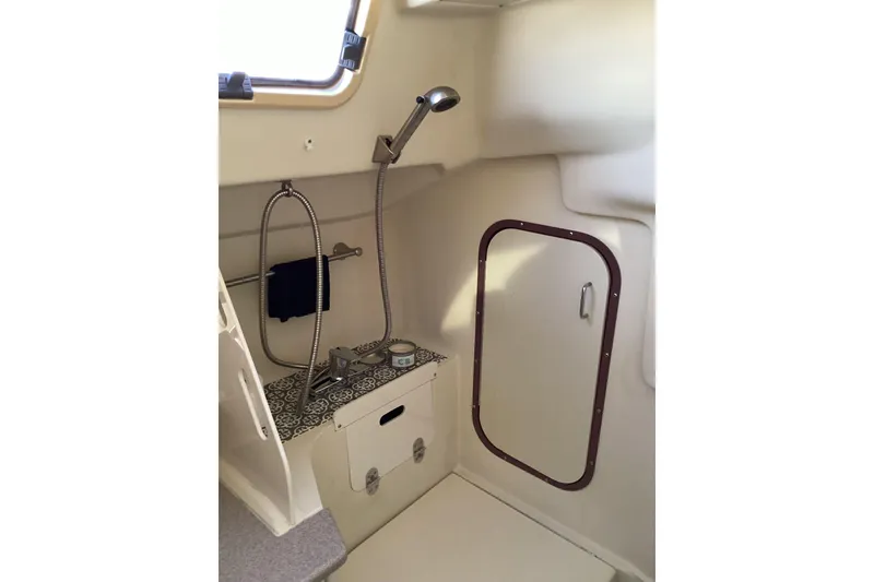Slide: The Image of Interior of a 1999 Hunter 340 sailboat bathroom with shower and storage. - 22