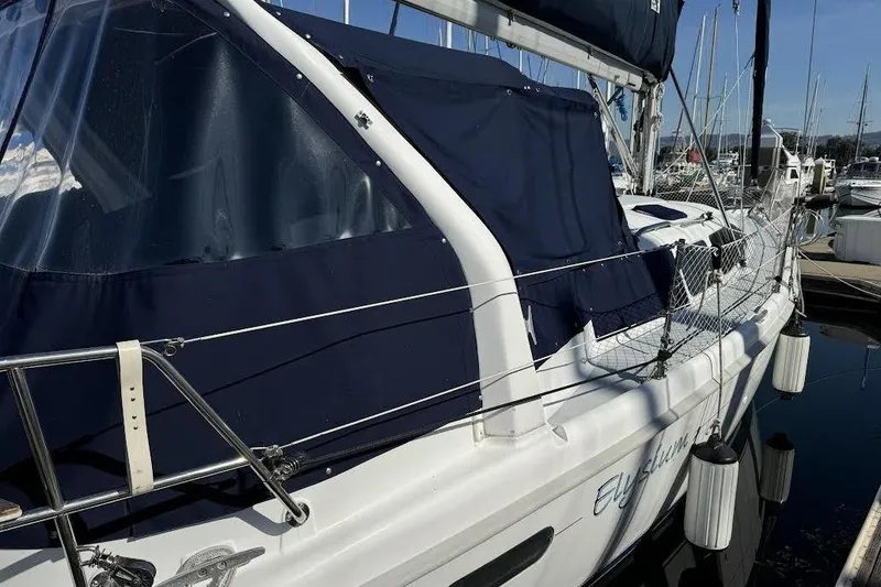 Slide: The Image of Sailboat Hunter 340, 1999 model, docked with blue canvas cover. - 3