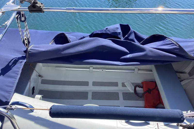 Slide: The Image of Hunter 340 sailboat cockpit with blue cover, 1999 model, docked on calm water. - 4