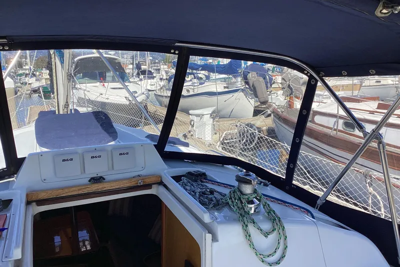 Slide: The Image of Interior view of a 1999 Hunter 340 sailboat cockpit, docked at a marina. - 5