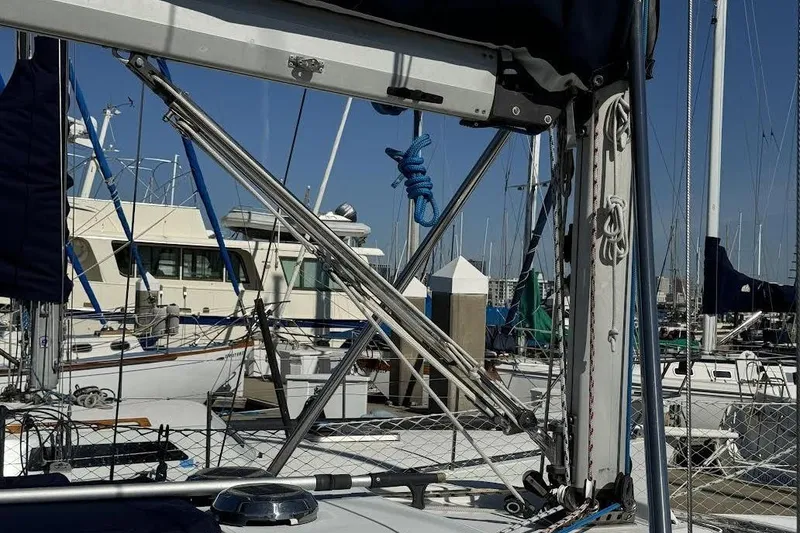 Slide: The Image of Sailboats docked at a marina, featuring a 1999 Hunter 340 sailboat. - 6