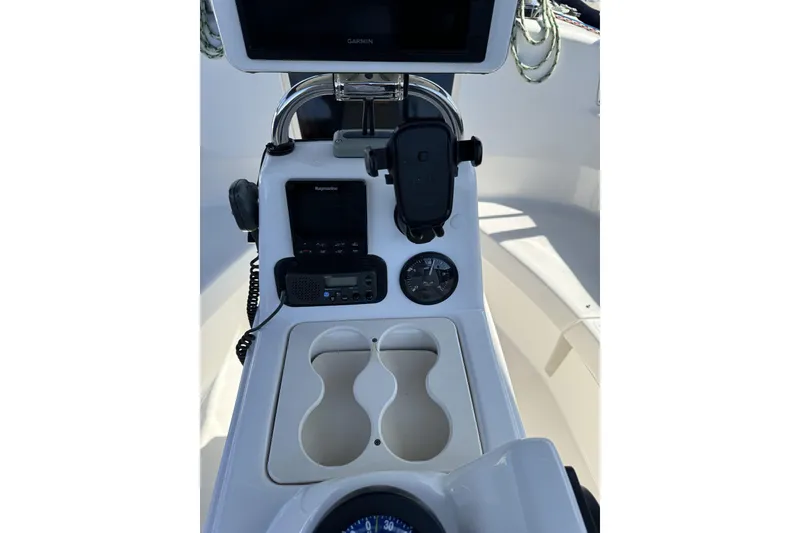 Slide: The Image of Cockpit of 1999 Hunter 340 sailboat with navigation equipment and cup holders. - 9
