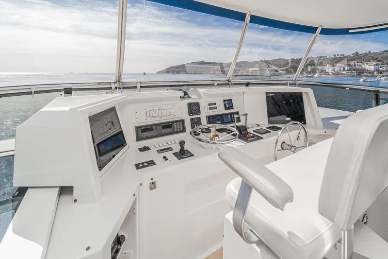 Slide: The Image of Cockpit of 1995 Nordlund Motor Yacht with modern navigation equipment and ocean view. - 19