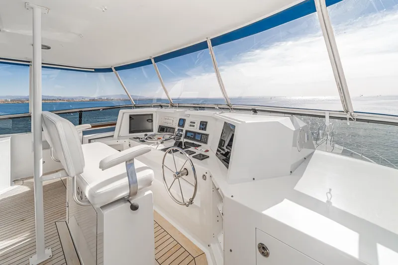 Slide: The Image of Cockpit of 1995 Nordlund Motor Yacht with steering wheel, controls, and ocean view. - 20