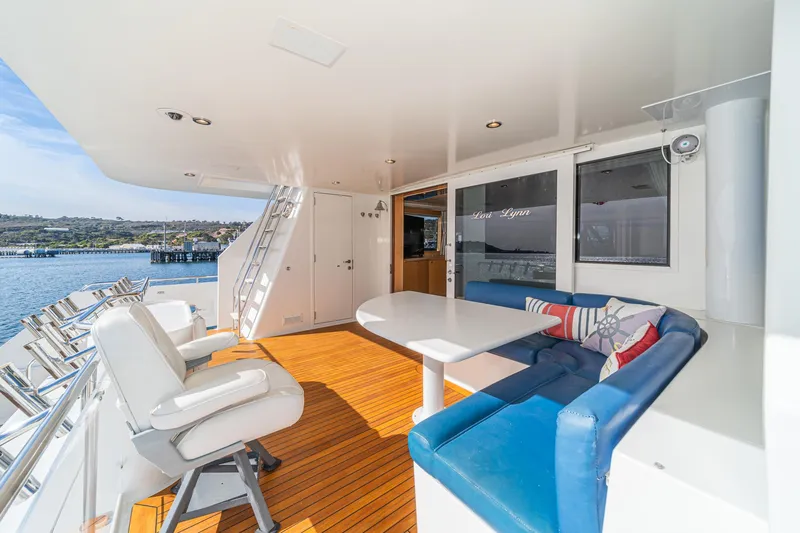 Slide: The Image of Luxurious 1995 Nordlund Cockpit Motor Yacht with spacious deck seating and scenic water view. - 26