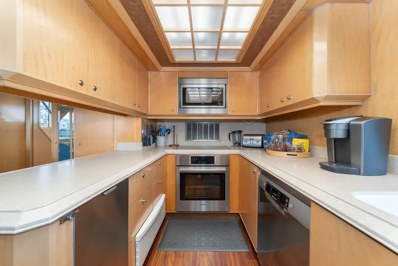 Slide: The Image of Spacious kitchen in 1995 Nordlund Cockpit Motor Yacht with modern appliances and wood cabinetry. - 33
