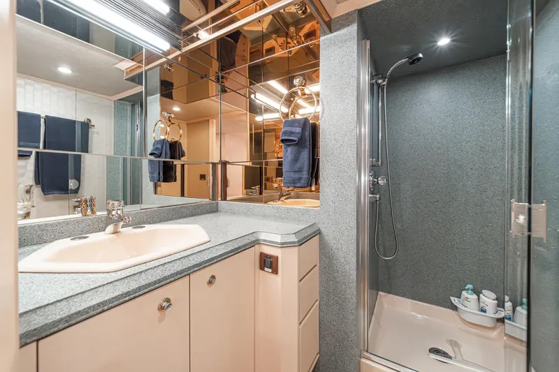 Slide: The Image of Luxurious bathroom in a 1995 Nordlund Cockpit Motor Yacht with modern fixtures and mirrored walls. - 43