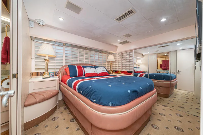 Slide: The Image of Luxurious bedroom in 1995 Nordlund Cockpit Motor Yacht with mirrored closet and elegant decor. - 44