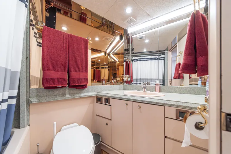 Slide: The Image of Luxurious bathroom in a 1995 Nordlund Cockpit Motor Yacht with red towels and modern fixtures. - 45