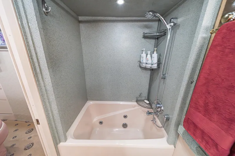 Slide: The Image of Luxurious bathroom with shower and tub in 1995 Nordlund Cockpit Motor Yacht. - 46