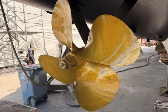 Slide: The Image of Golden propeller of a 1995 Nordlund Cockpit Motor Yacht in a shipyard. - 57