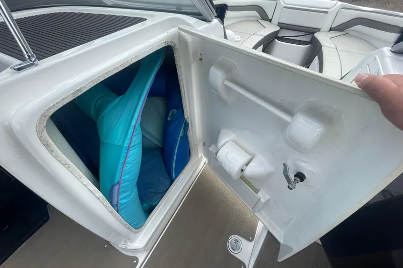 Slide: The Image of Storage compartment on a 2015 Yamaha Boats 242 Limited S, with life jackets inside. - 10